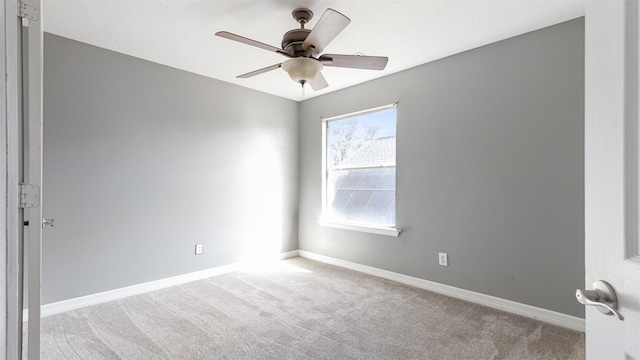 spare room with light colored carpet and ceiling fan