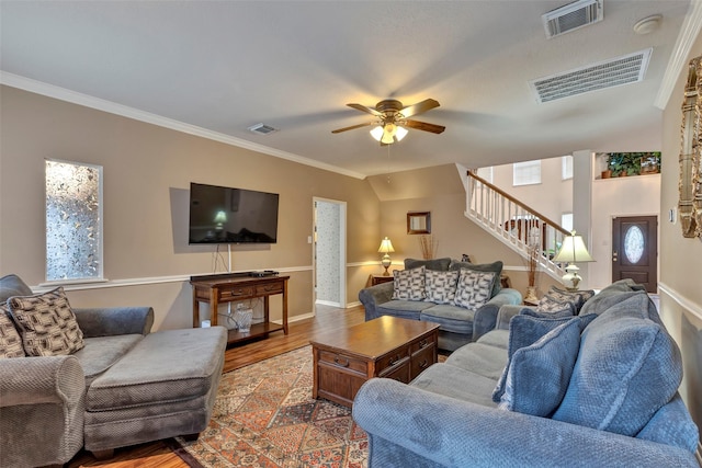 living room with crown molding, ceiling fan, and hardwood / wood-style floors