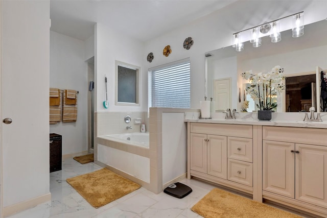 bathroom featuring vanity and tiled bath