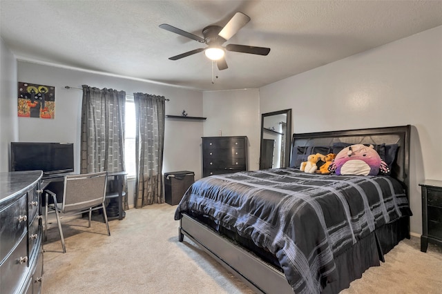 carpeted bedroom with ceiling fan and a textured ceiling