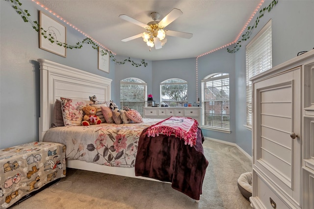 bedroom with multiple windows, carpet floors, and ceiling fan