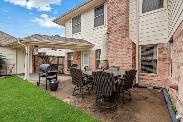 view of patio with area for grilling and ceiling fan