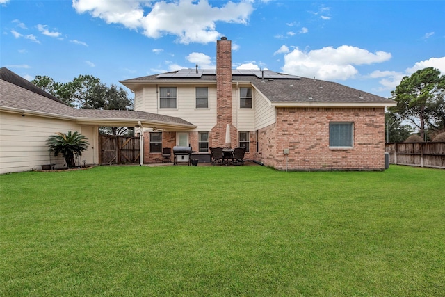 back of house featuring a lawn