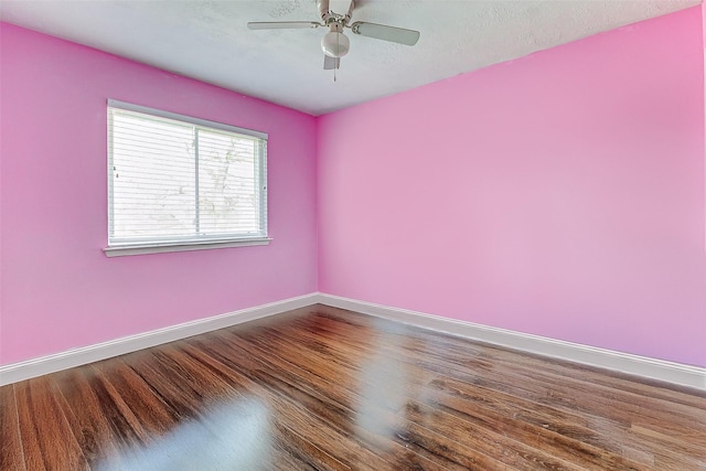 empty room featuring hardwood / wood-style flooring, a textured ceiling, and ceiling fan