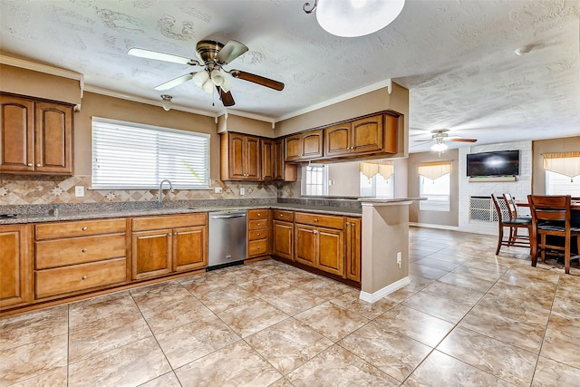 kitchen with dishwasher, sink, decorative backsplash, and a textured ceiling