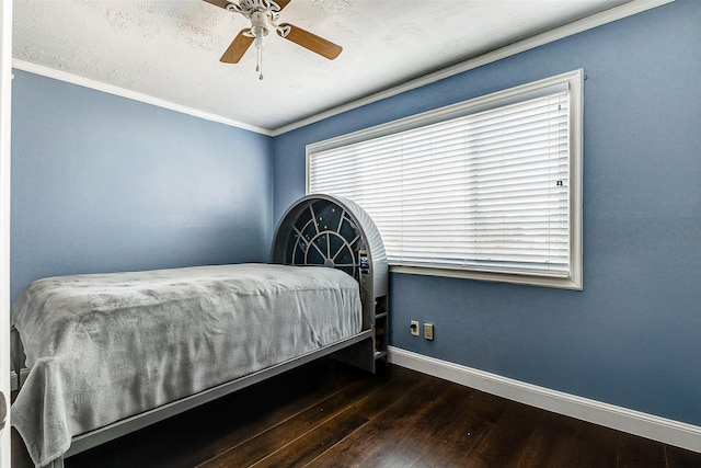 bedroom with ceiling fan, ornamental molding, and dark hardwood / wood-style flooring