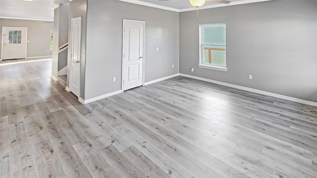 spare room featuring ceiling fan, ornamental molding, and light wood-type flooring