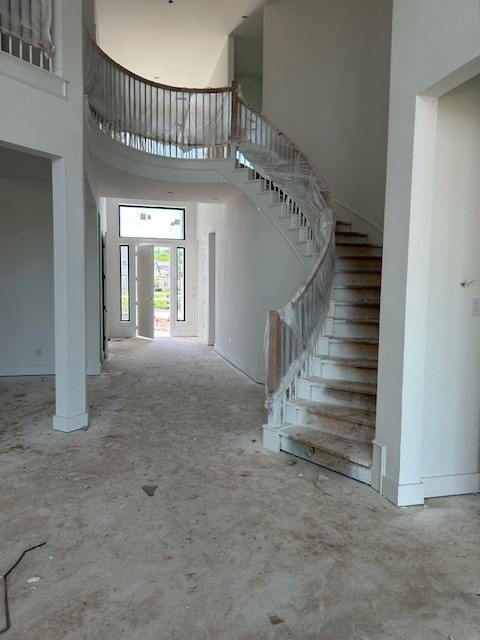 4330 Southpoint Way N, Fulshear, TX 77441 - stairway featuring a towering ceiling and baseboards
