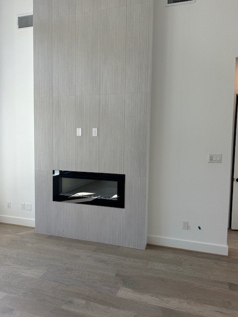 4330 Southpoint Way N, Fulshear, TX 77441 - detailed view of a fireplace, wood finished floors, and baseboards