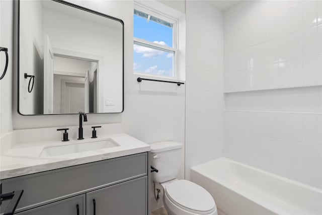 full bathroom with vanity, tiled shower / bath combo, and toilet