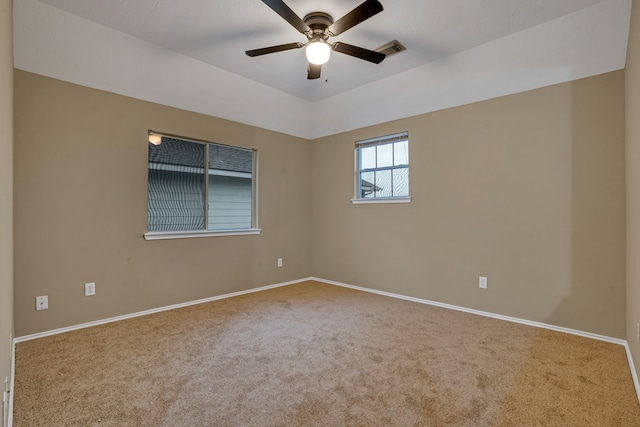 carpeted spare room featuring ceiling fan