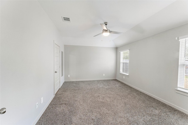 carpeted empty room featuring lofted ceiling and ceiling fan