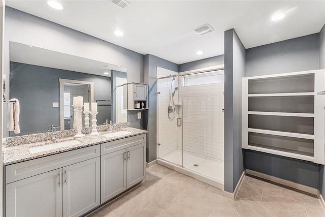 bathroom with vanity, tile patterned floors, and a shower with door