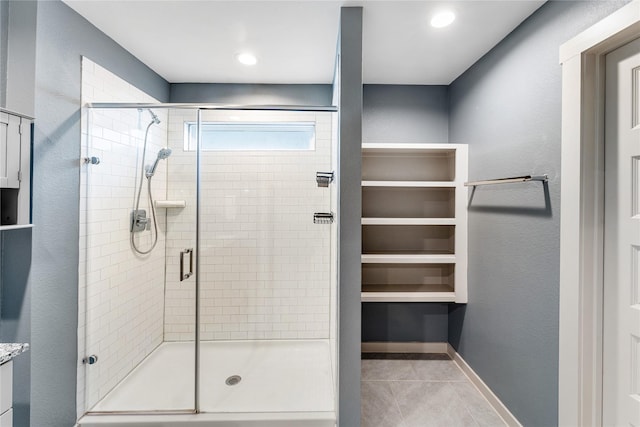 bathroom with tile patterned flooring and a shower with shower door