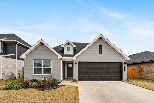 view of front of house featuring a garage and a front lawn