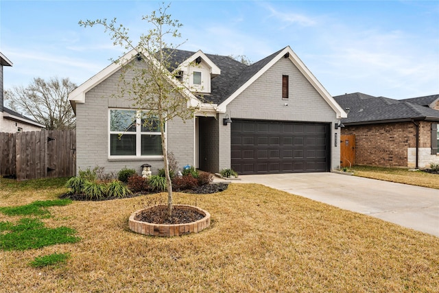 view of front of home featuring a garage and a front yard