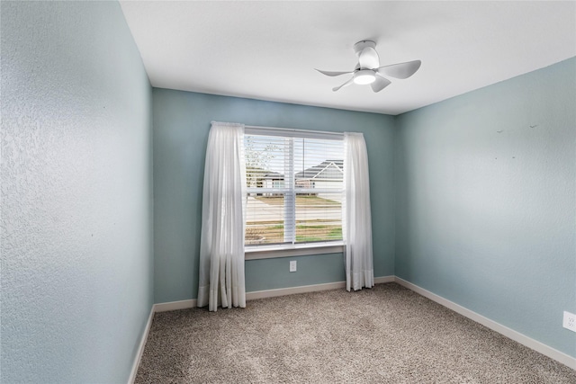 carpeted empty room with ceiling fan