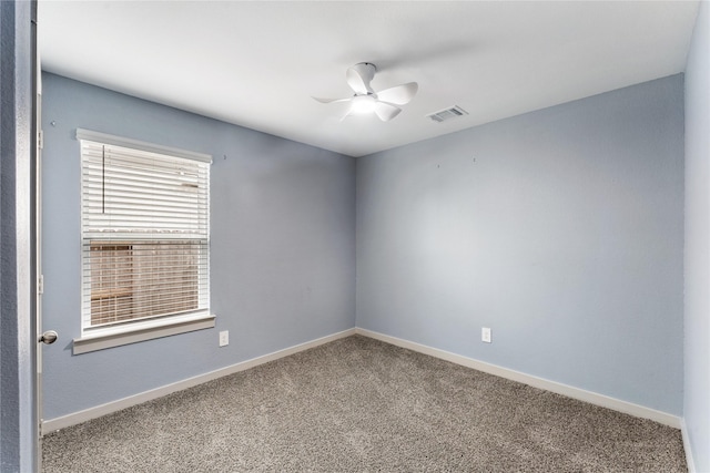 carpeted spare room with ceiling fan