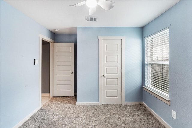 unfurnished bedroom with light carpet and ceiling fan