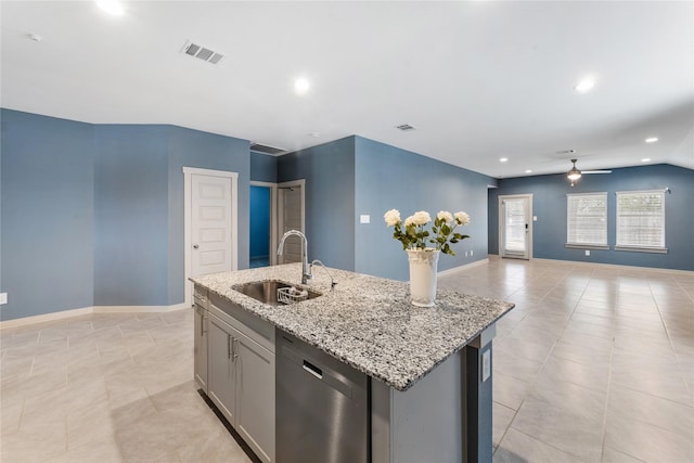 kitchen featuring sink, gray cabinets, dishwasher, an island with sink, and light stone countertops