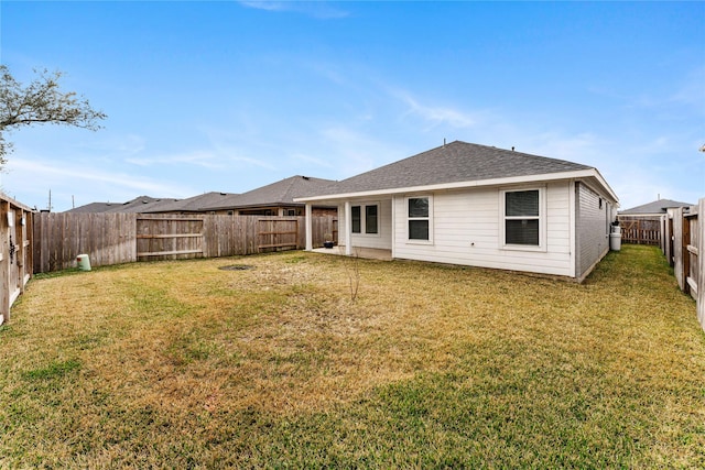 rear view of house with a lawn