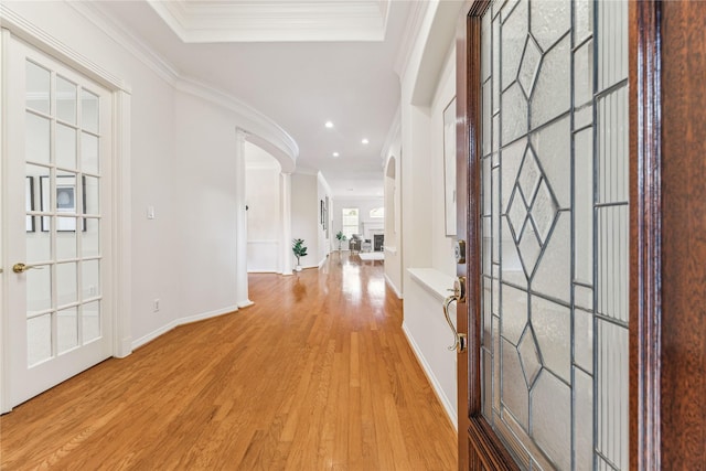 hall featuring light hardwood / wood-style flooring and ornamental molding