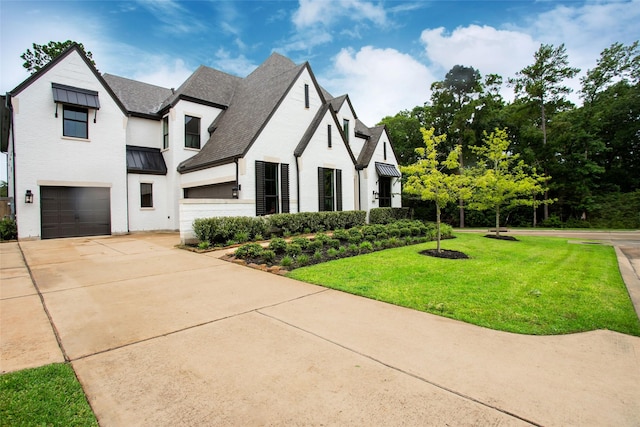 view of front of home featuring a garage and a front lawn