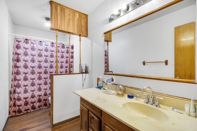 bathroom featuring hardwood / wood-style flooring and vanity