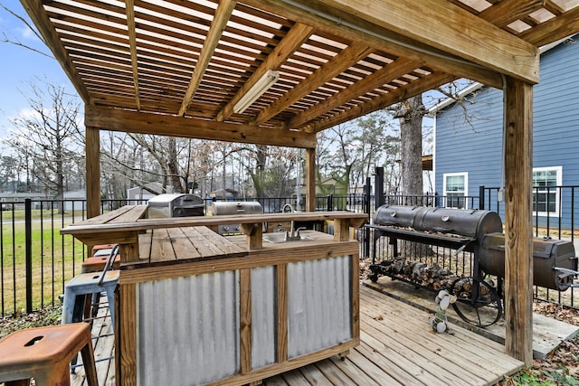 deck featuring a bar and grilling area