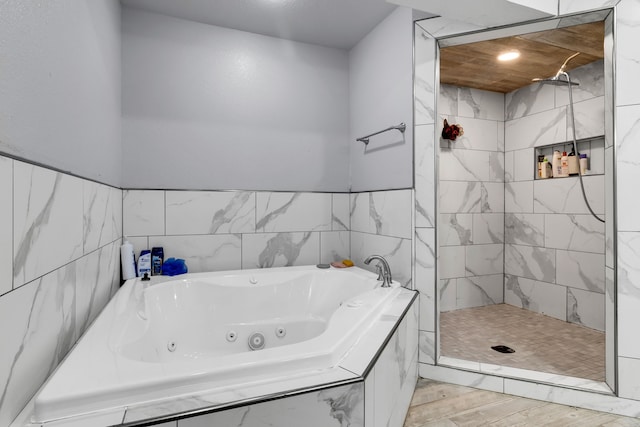 bathroom with shower with separate bathtub and hardwood / wood-style floors