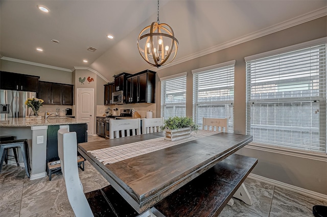 dining space with crown molding, lofted ceiling, and an inviting chandelier