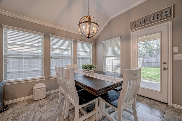 dining area featuring an inviting chandelier, lofted ceiling, crown molding, and a wealth of natural light