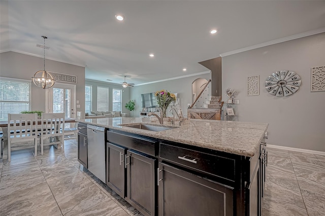 kitchen featuring pendant lighting, sink, dishwasher, light stone countertops, and a center island with sink