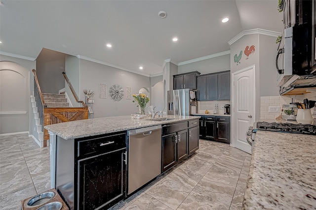 kitchen featuring appliances with stainless steel finishes, sink, a kitchen island with sink, crown molding, and light stone countertops