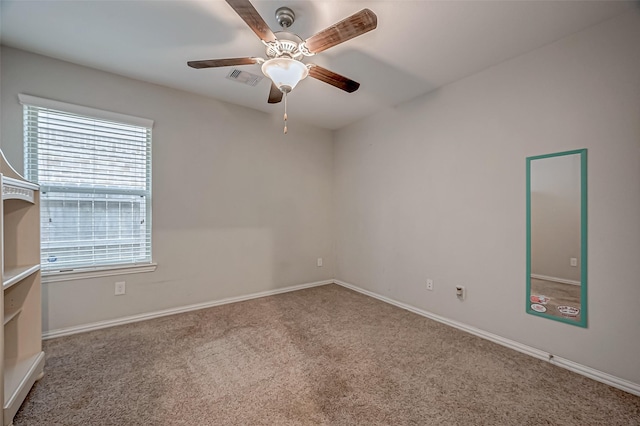 carpeted spare room with ceiling fan