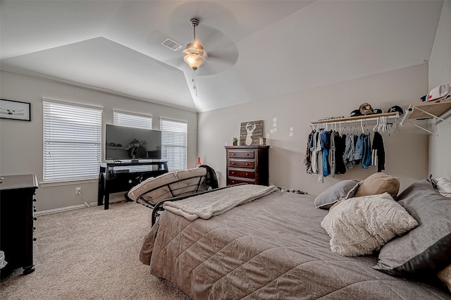 carpeted bedroom with vaulted ceiling and ceiling fan