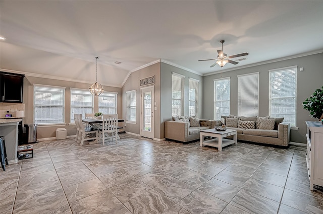 living room featuring ceiling fan with notable chandelier, ornamental molding, light tile patterned flooring, and vaulted ceiling