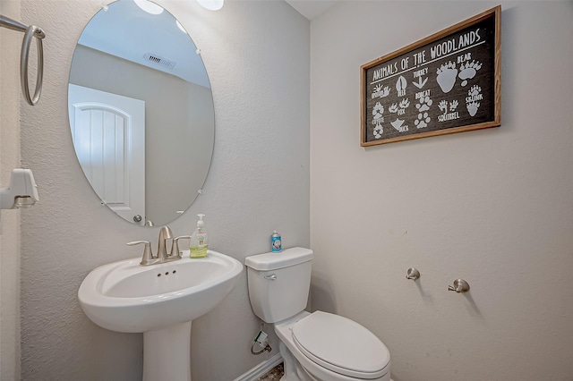 bathroom featuring toilet and sink