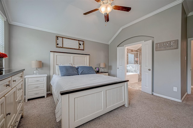 carpeted bedroom featuring lofted ceiling, ensuite bath, ornamental molding, and ceiling fan