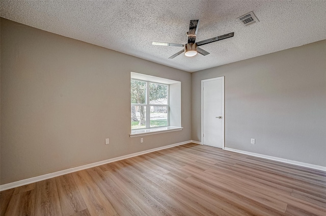 unfurnished room with ceiling fan, a textured ceiling, and light hardwood / wood-style floors