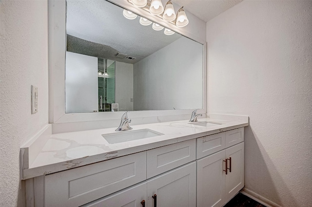 bathroom featuring vanity and a textured ceiling