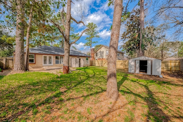 view of yard with a storage shed and a patio