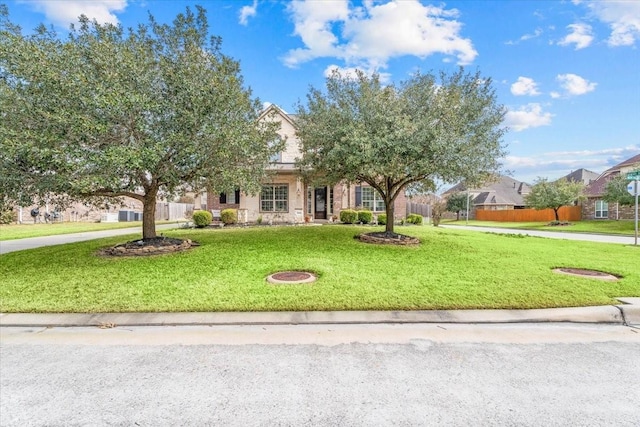 view of property hidden behind natural elements featuring a front lawn