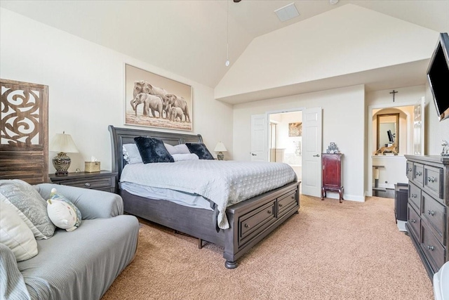 bedroom with connected bathroom, high vaulted ceiling, and light carpet