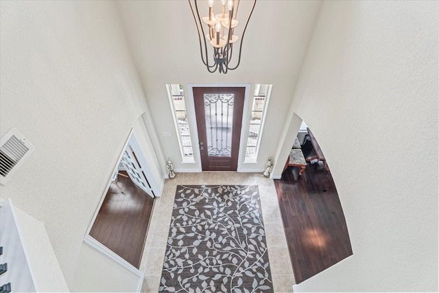 entrance foyer featuring an inviting chandelier and a high ceiling