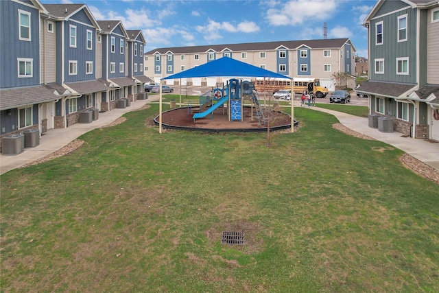 view of jungle gym featuring a yard and central air condition unit