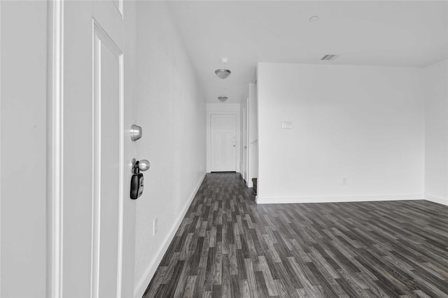 corridor featuring dark hardwood / wood-style floors