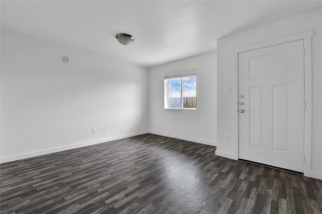 interior space with dark hardwood / wood-style floors and a textured ceiling