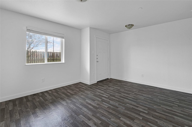 empty room with dark wood-type flooring