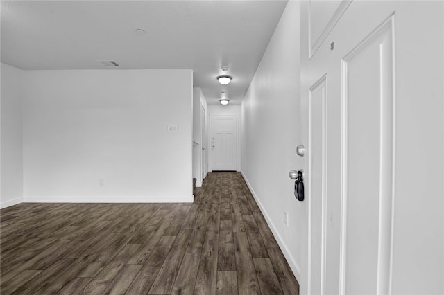 hallway featuring dark wood-type flooring